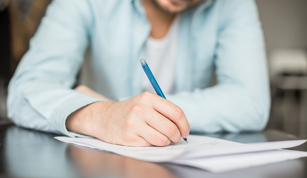 Man writing handwritten letter